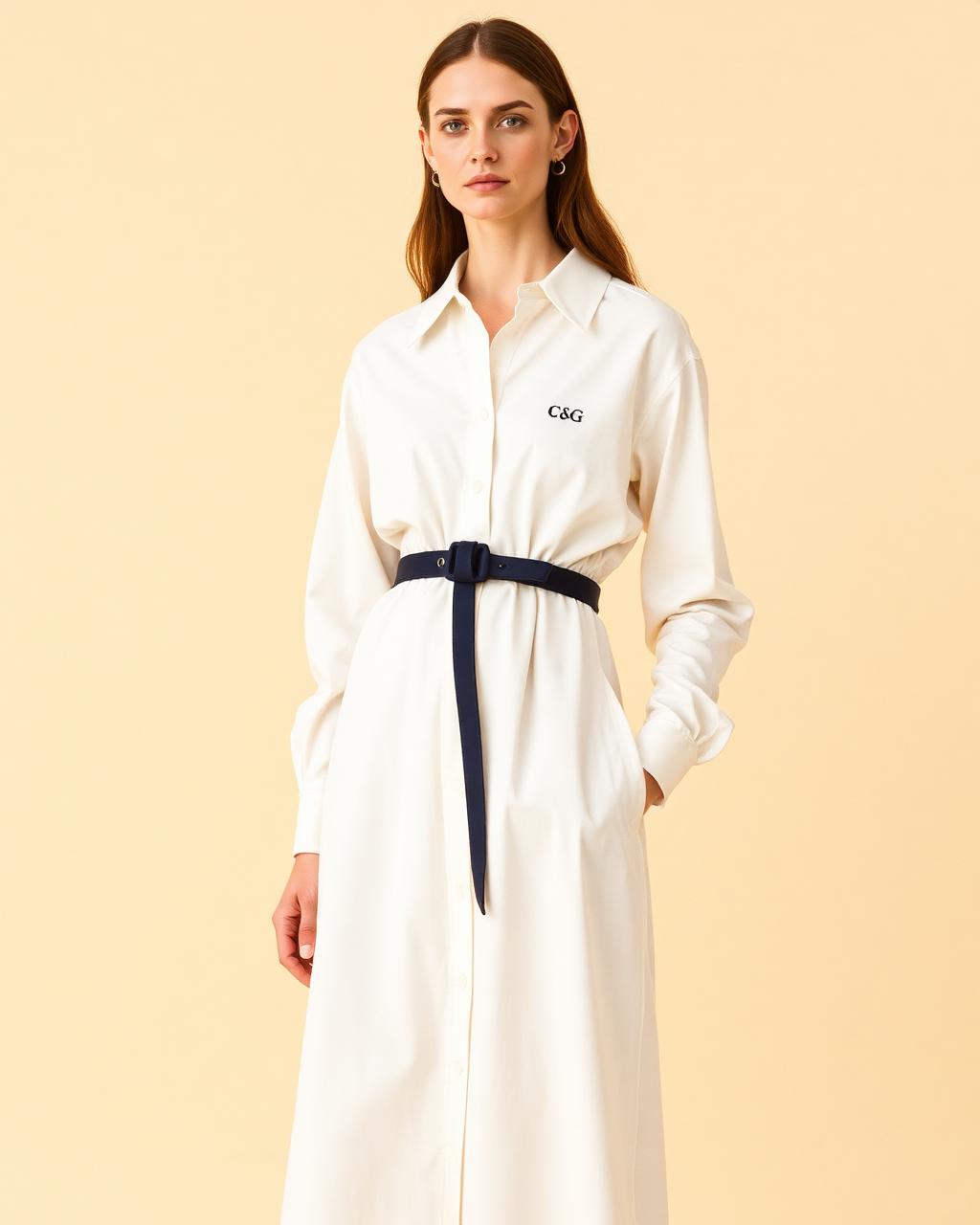 Model in an ivory Cloth & Glitter shirt dress with a slim navy belt